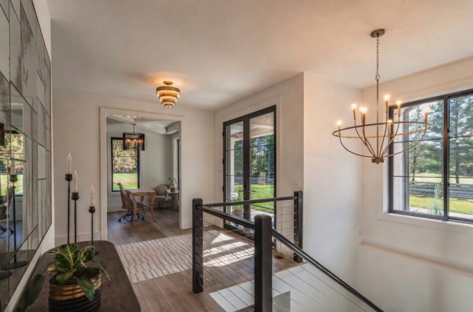 Oakmont II interior hallway with cable railing staircase, hardwood floors, and designer lighting by Justin Doyle Homes — custom home builder Cincinnati