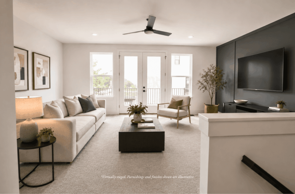 Living room in a Lebanon Landing 3 bedroom townhome with French doors opening to a private balcony, neutral palette, and contemporary furnishings.