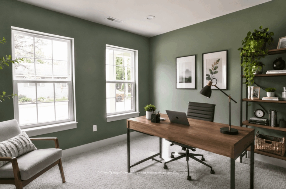 First-floor home office in a Lebanon Landing 2 bedroom townhome with sage green walls, walnut desk, and natural light from two large windows.