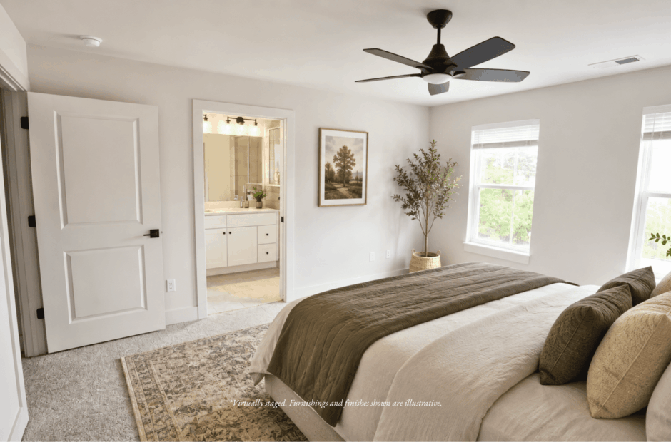 Primary bedroom in a Lebanon Landing 3 bedroom townhome with king bed, ensuite bathroom access, and natural light from two windows.