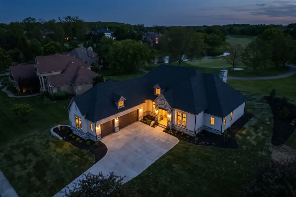 Aerial view at dusk of a Justin Doyle Homes ranch on the golf course at Country Club of the North in Beavercreek, Ohio