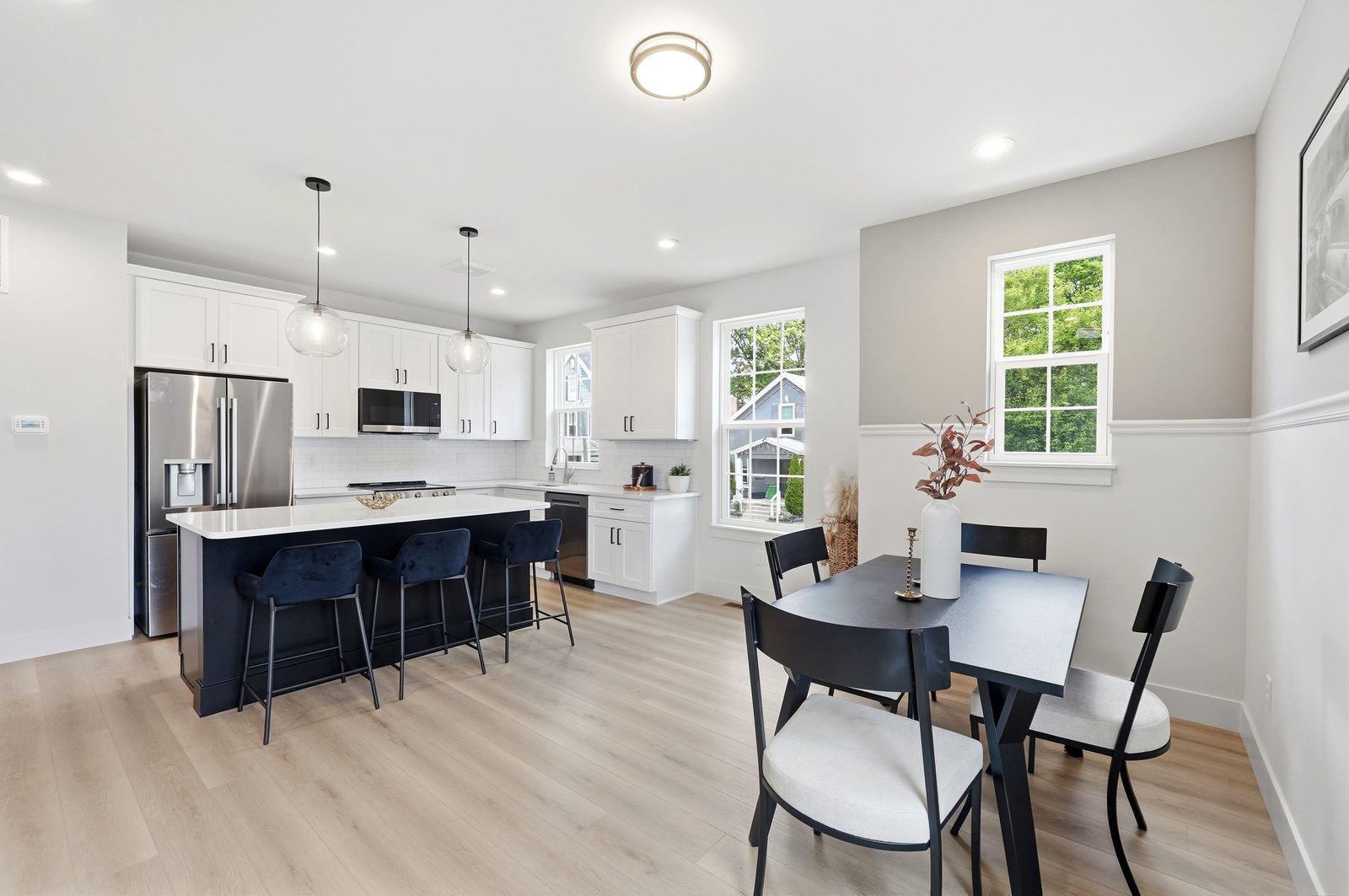 Kitchen with a large island and the dining room on the main level of the Lebanon Landing 3 bedroom townhome
