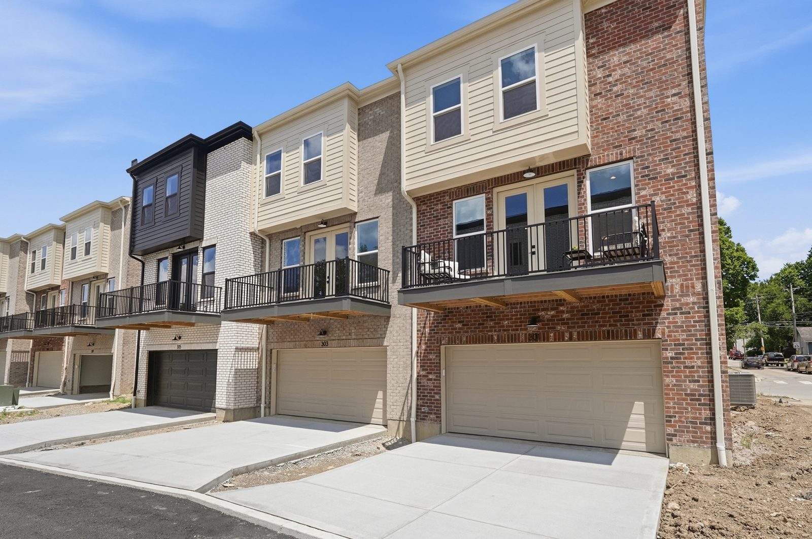 Two-car garages and second-floor decks behind the Lebanon Landing 3 bedroom townhomes
