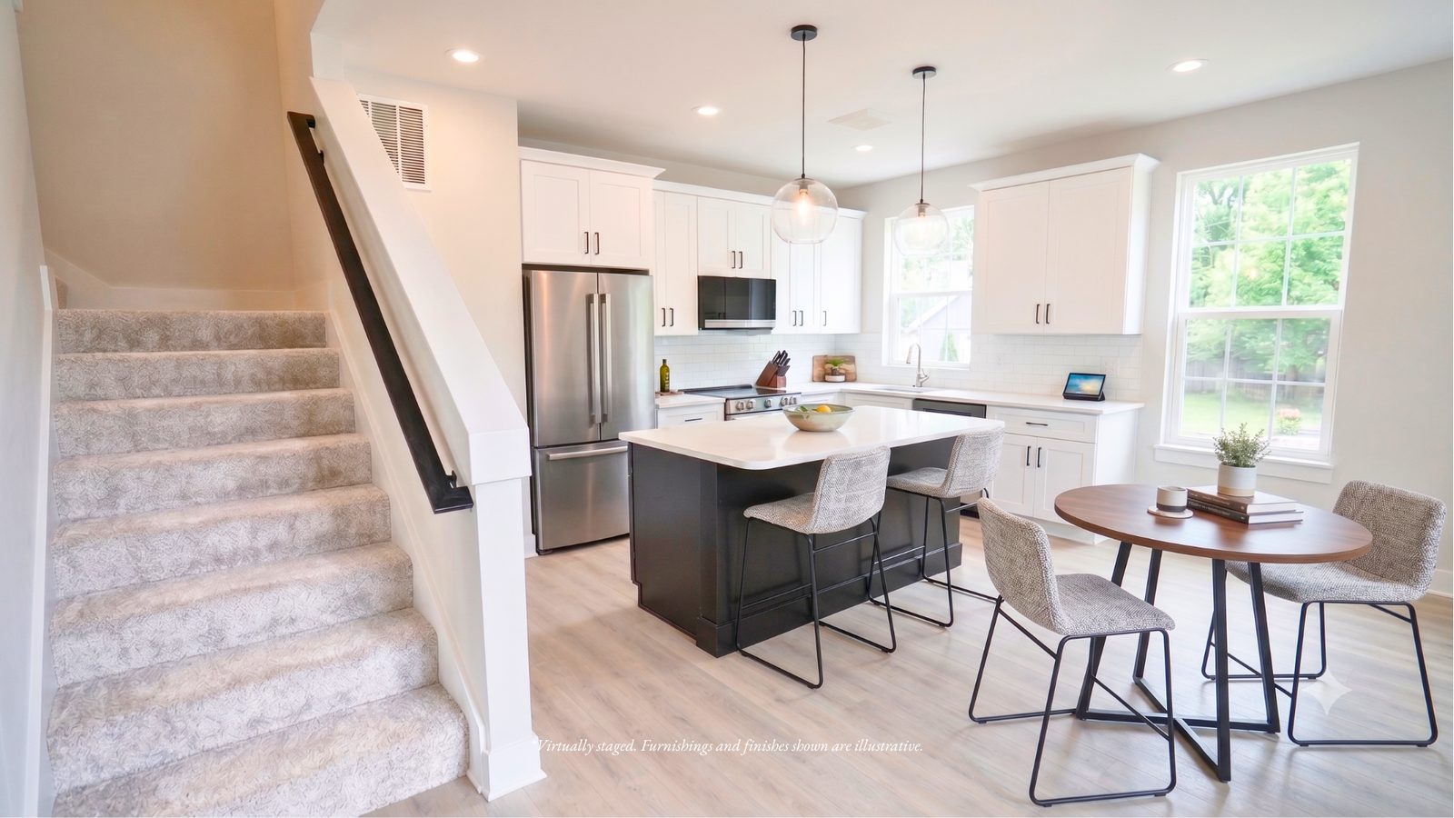 Open kitchen and dining area on the main living level, with stairs up to the bedroom floor