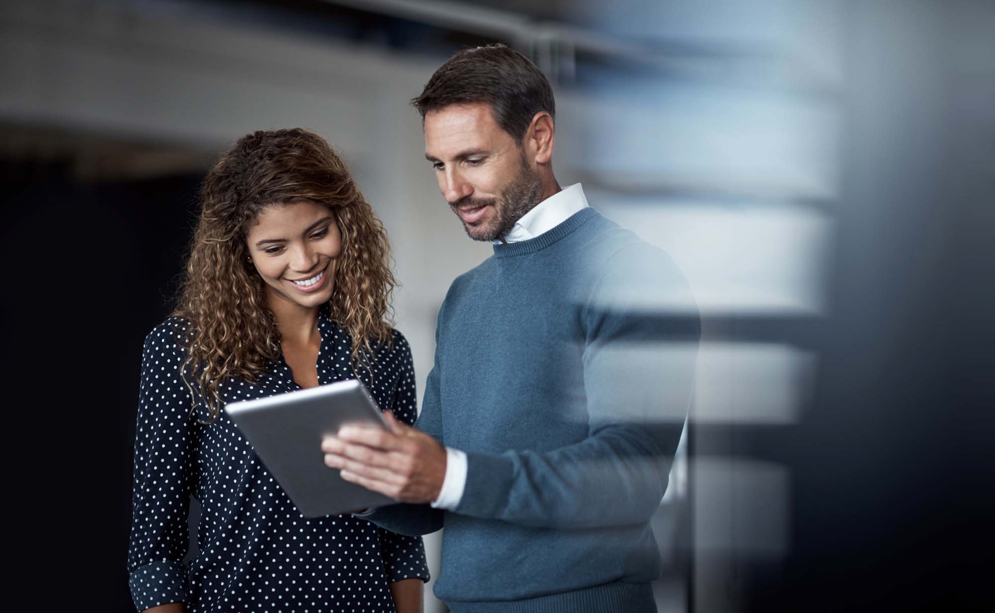 two people reviewing information on device