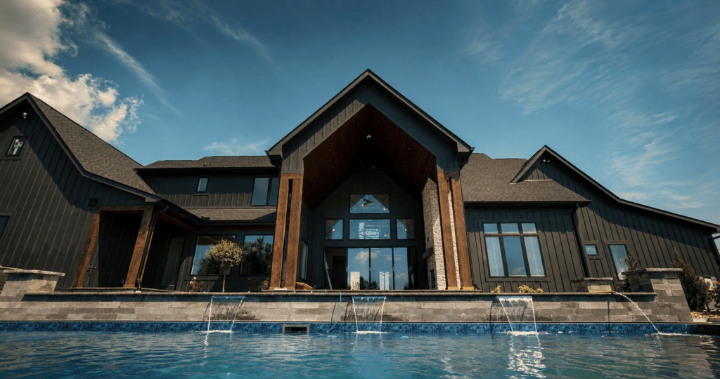 Rear elevation and pool with water features at The Ironwood, an 8,126 square foot custom home by Justin Doyle Homes